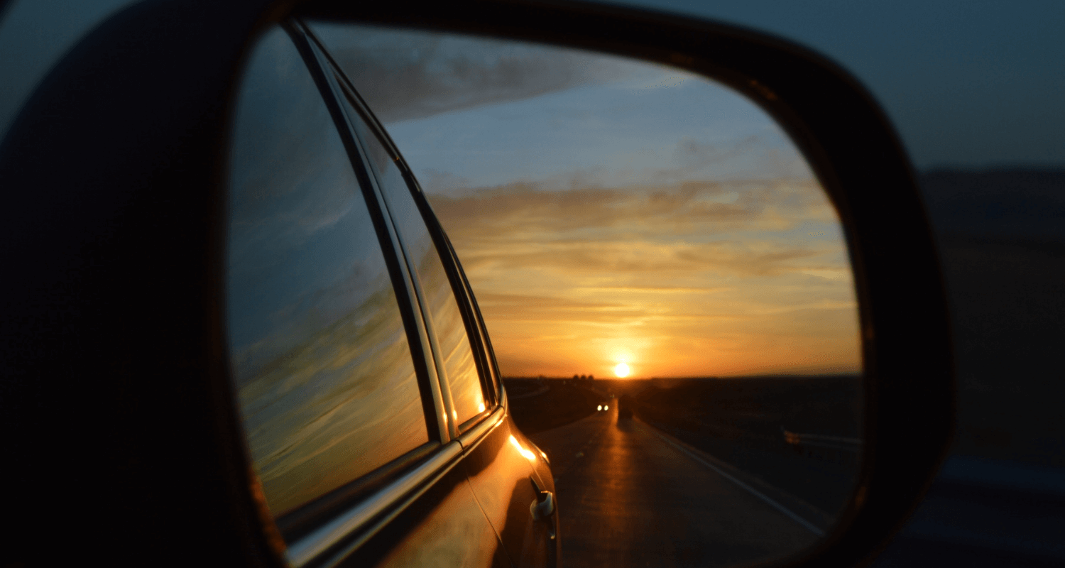 Driving your values, image of sunrise from rear view mirror