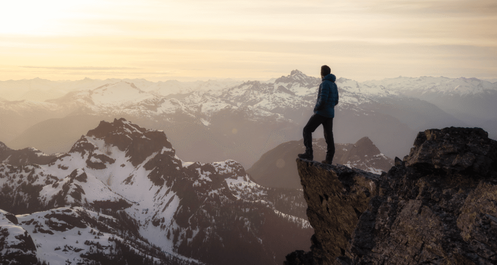 Mountain Climbing:Man on top of cliff.